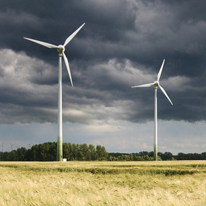 Zwei Windräder in der Landschaft vor aufziehendem Unwetter